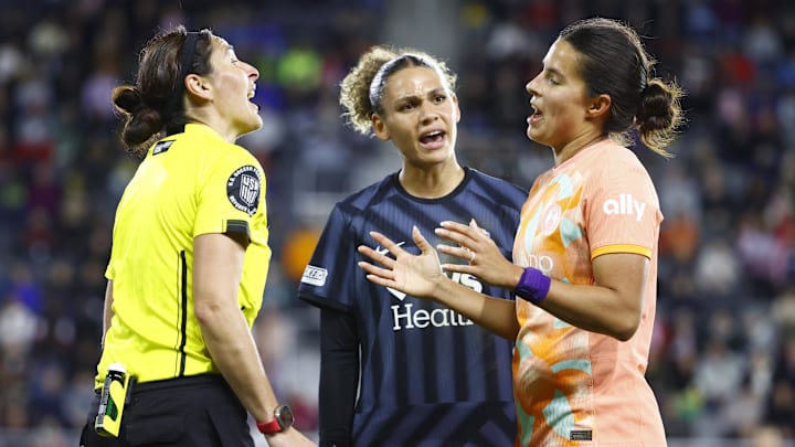 Washington Spirit forward Trinity Rodman (center) and Orlando Pride defender Emily Sams (right) speak with a match official
