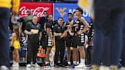 Feb 19, 2025; Morgantown, West Virginia, USA; Cincinnati Bearcats players pause during a timeout during the second half against the West Virginia Mountaineers at WVU Coliseum. Mandatory Credit: Ben Queen-Imagn Images