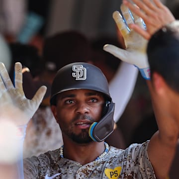 Sep 8, 2024; San Diego, California, USA; San Diego Padres second baseman Xander Bogaerts (2) celebrates with teammates after hitting a two run home run during the eighth inning against the San Francisco Giants at Petco Park. Mandatory Credit: Chadd Cady-Imagn Images