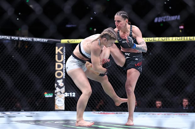 Miranda Maverick (red gloves) fights Jamey-Lyn Horth (blue gloves) at Amalie Arena.