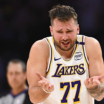 Mar 22, 2025; Los Angeles, California, USA; Los Angeles Lakers guard Luka Doncic (77) reacts to a call from referee Courtney Kirkland (61) against the Chicago Bulls during the second half at Crypto.com Arena. Mandatory Credit: Jonathan Hui-Imagn Images