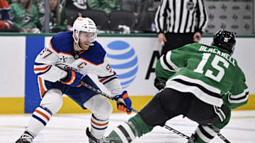 Edmonton Oilers center Connor McDavid (97) skates with the puck past Dallas Stars center Colin Blackwell (15)