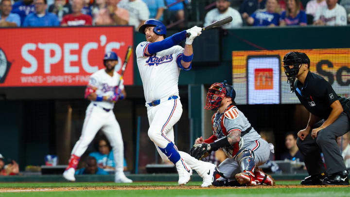 Aug 17, 2024; Arlington, Texas, USA;  Texas Rangers designated hitter Carson Kelly (18) hits an rbi single during the second inning against the Minnesota Twins at Globe Life Field. Mandatory Credit: Kevin Jairaj-USA TODAY Sports