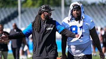 Detroit Lions defensive coordinator Kelvin Sheppard, left, talk to defensive tackle Tyleik Williams (91) as they walk off the field after practice during training camp at Meijer Performance Center in Allen Park on Thursday, July 24, 2025.