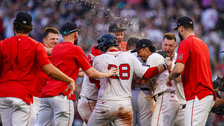 Jul 31, 2024; Boston, Massachusetts, USA; Boston Red Sox third baseman Rafael Devers (11) is congratulated after hitting a double to center field to drive in the winning run against tech Seattle Mariners in the tenth inning at Fenway Park. Mandatory Credit: David Butler II-USA TODAY Sports