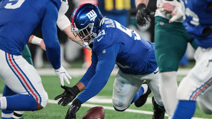 Jan 7, 2024; East Rutherford, New Jersey, USA; New York Giants linebacker Azeez Ojulari (51) recovers a fumble by Philadelphia Eagles quarterback Marcus Mariota (not pictured) during the second half at MetLife Stadium.  