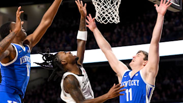 Jan 25, 2025; Nashville, Tennessee, USA;  Vanderbilt Commodores guard Jason Edwards (1) lays the ball in  over Kentucky Wildcats guard Travis Perry (11) and forward Brandon Garrison (10) during the first half at Memorial Gymnasium. Mandatory Credit: Steve Roberts-Imagn Images