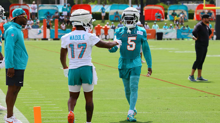 Miami Dolphins cornerback Jalen Ramsey (5) and wide receiver Jaylen Waddle (17) shake hands during training camp at Baptist Health Training Complex.