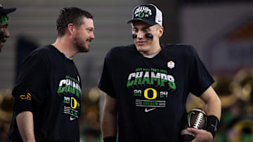 Jan 1, 2024; Glendale, AZ, USA; Oregon Ducks quarterback Bo Nix (right) celebrates with head coach Dan Lanning after defeating the Liberty Flames during the 2024 Fiesta Bowl at State Farm Stadium. Mandatory Credit: Mark J. Rebilas-USA TODAY Sports