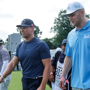 The Miz talks to Detroit Lions Aidan Hutchinson after teeing off the 15th during AREA 313 Celebrity Scramble at Detroit Golf Club