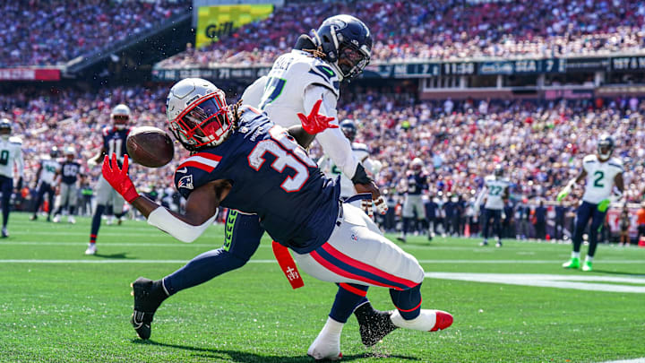 Sep 15, 2024; Foxborough, Massachusetts, USA; New England Patriots running back Rhamondre Stevenson (38) misses the pass against Seattle Seahawks linebacker Jerome Baker (17) in the second quarter at Gillette Stadium. Mandatory Credit: David Butler II-Imagn Images