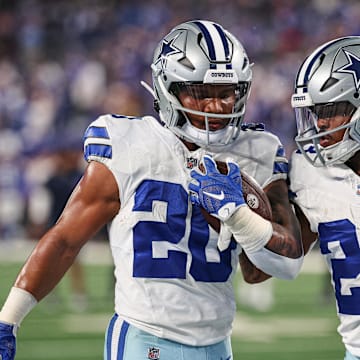 Dallas Cowboys running backs Tony Pollard and Rico Dowdle warm up before a game against the New York Giants at MetLife Stadium. 