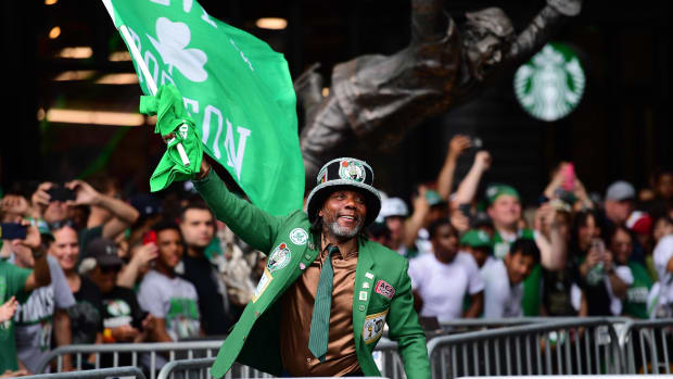 Jun 21, 2024; Boston, MA, USA;  A fan waves a banner prior to the Boston Celtics Championship parade. Mandatory Credit: Bob DeChiara-USA TODAY Sports