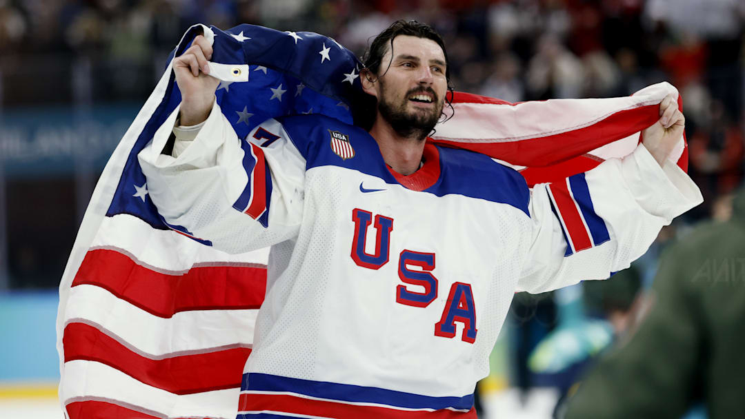 Feb 22, 2026; Milan, Italy;  Connor Hellebuyck (37) of the United States celebrates after defeating Canada in the men's ice hockey gold medal game during the Milano Cortina 2026 Olympic Winter Games at Milano Santagiulia Ice Hockey Arena. Mandatory Credit: Geoff Burke-Imagn Images