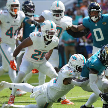 Miami Dolphins safety Jevon Holland (8) punches the ball away from Jacksonville Jaguars running back Travis Etienne Jr. (1) causing a fumble that was recovered by the Dolphins in the end zone during the third quarter at Hard Rock Stadium.