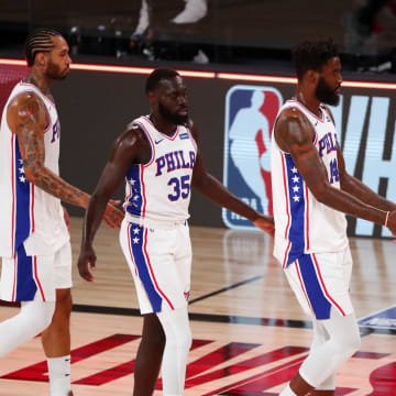 Aug 14, 2020; Lake Buena Vista, Florida, USA; Philadelphia 76ers guard Marial Shayok (35) and forward Norvel Pelle (14) celebrate with teammates after defeating the Houston Rockets in a NBA basketball game at AdventHealth Arena. Mandatory Credit: Kim Klement-USA TODAY Sports