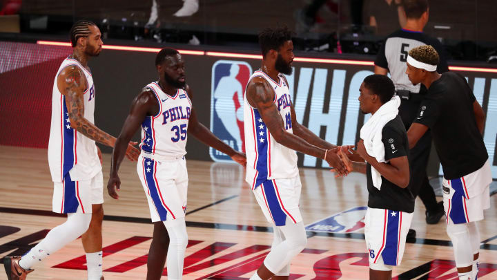 Aug 14, 2020; Lake Buena Vista, Florida, USA; Philadelphia 76ers guard Marial Shayok (35) and forward Norvel Pelle (14) celebrate with teammates after defeating the Houston Rockets in a NBA basketball game at AdventHealth Arena. Mandatory Credit: Kim Klement-USA TODAY Sports