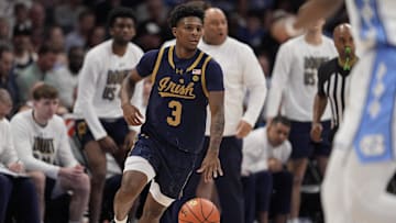 Mar 12, 2025; Charlotte, NC, USA; Notre Dame Fighting Irish guard Markus Burton (3) brings the ball up court against the North Carolina Tar Heels during the first half at Spectrum Center.