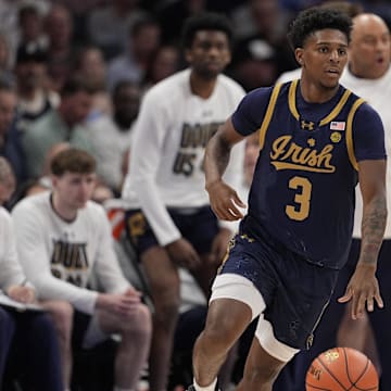 Mar 12, 2025; Charlotte, NC, USA; Notre Dame Fighting Irish guard Markus Burton (3) brings the ball up court against the North Carolina Tar Heels during the first half at Spectrum Center.