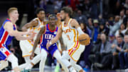 Nov 18, 2024; Sacramento, California, USA; Atlanta Hawks guard Trae Young (11) is defended by Sacramento Kings guard Keon Ellis (23) and guard Kevin Huerter (9) during the fourth quarter at Golden 1 Center. Mandatory Credit: Sergio Estrada-Imagn Images