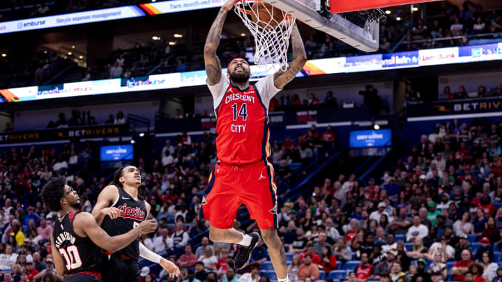 Mar 16, 2024; New Orleans, Louisiana, USA;  New Orleans Pelicans forward Brandon Ingram (14) dunks the ball against Portland Trail Blazers guard Dalano Banton (5) and guard Scoot Henderson (00) during the second half at Smoothie King Center. Mandatory Credit: Stephen Lew-USA TODAY Sports