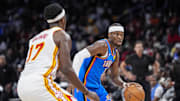 Oct 25, 2025; Atlanta, Georgia, USA; Oklahoma City Thunder guard Shai Gilgeous-Alexander (2) dribbles against Atlanta Hawks forward Onyeka Okongwu (17) during the second half at State Farm Arena. Mandatory Credit: Dale Zanine-Imagn Images