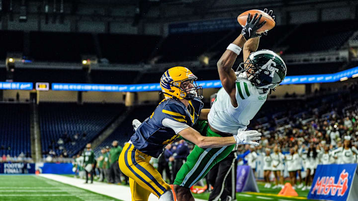 Detroit Cass Tech WR Corey Sadler Jr. catches a touchdown pass, while being covered by Hudsonville Ty Ykema in the second quarter, during the MHSAA Division 1 football finals at Ford Field in Detroit on Saturday, Nov. 30, 2024.