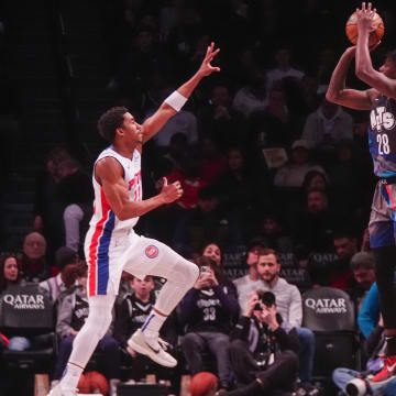 Apr 6, 2024; Brooklyn, New York, USA; Brooklyn Nets power forward Dorian Finney-Smith (28) shoots a three-point jump shot against Detroit Pistons point guard Jaden Ivey (23) during the first half at Barclays Center. Mandatory Credit: Gregory Fisher-USA TODAY Sports