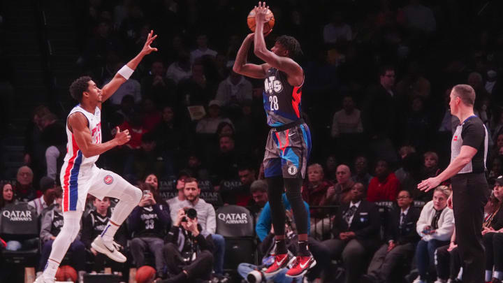 Apr 6, 2024; Brooklyn, New York, USA; Brooklyn Nets power forward Dorian Finney-Smith (28) shoots a three-point jump shot against Detroit Pistons point guard Jaden Ivey (23) during the first half at Barclays Center. Mandatory Credit: Gregory Fisher-USA TODAY Sports