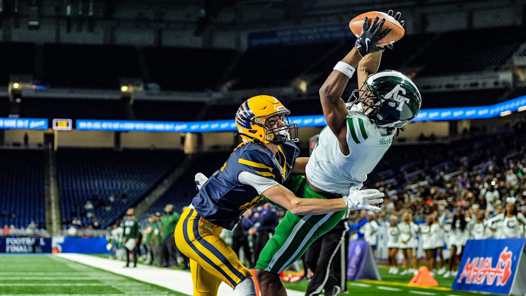 Detroit Cass Tech WR Corey Sadler Jr. catches a touchdown pass, while being covered by Hudsonville Ty Ykema in the second quarter, during the MHSAA Division 1 football finals at Ford Field in Detroit on Saturday, Nov. 30, 2024.