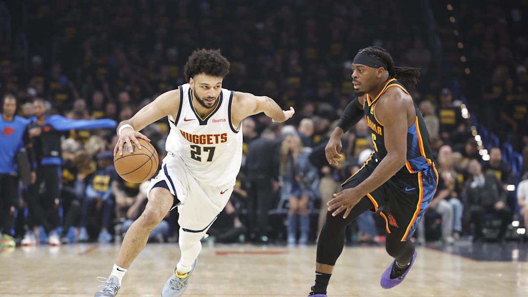 May 7, 2025; Oklahoma City, Oklahoma, USA; Denver Nuggets guard Jamal Murray (27) drives down the court beside Oklahoma City Thunder guard Luguentz Dort (5) in the first quarter during game two of the second round for the 2025 NBA Playoffs at Paycom Center. Mandatory Credit: Alonzo Adams-Imagn Images