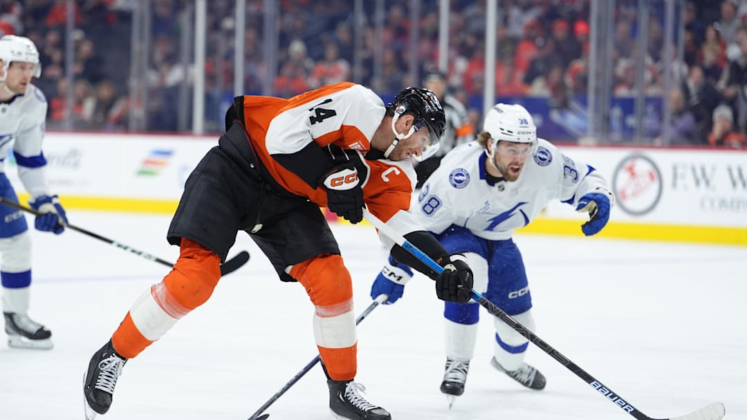 Jan 12, 2026; Philadelphia, Pennsylvania, USA; Philadelphia Flyers center Sean Couturier (14) shoots the puck against the Tampa Bay Lightning in the first period at Xfinity Mobile Arena. Mandatory Credit: Kyle Ross-Imagn Images