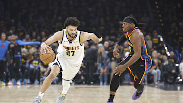May 7, 2025; Oklahoma City, Oklahoma, USA; Denver Nuggets guard Jamal Murray (27) drives down the court beside Oklahoma City Thunder guard Luguentz Dort (5) in the first quarter during game two of the second round for the 2025 NBA Playoffs at Paycom Center. Mandatory Credit: Alonzo Adams-Imagn Images