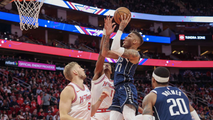 Dec 22, 2023; Houston, Texas, USA; Dallas Mavericks guard Dexter Dennis (17) shoots against Houston Rockets forward Amen Thompson (1) in the second half at Toyota Center. Mandatory Credit: Thomas Shea-USA TODAY Sports