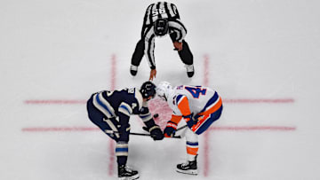 Blue Jackets center Cole Sillinger faces off against Islanders center JG Pageau.