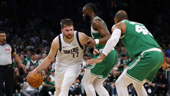 Jun 17, 2024; Boston, Massachusetts, USA; Dallas Mavericks guard Luka Doncic (77) dribbles the ball against Boston Celtics guard Jaylen Brown (7) during the second quarter in game five of the 2024 NBA Finals at TD Garden. Mandatory Credit: Peter Casey-USA TODAY Sports