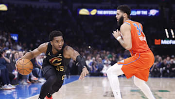 Jan 16, 2025; Oklahoma City, Oklahoma, USA;Cleveland Cavaliers guard Donovan Mitchell (45) drives around Oklahoma City Thunder forward Kenrich Williams (34) during the second quarter at Paycom Center. Mandatory Credit: Alonzo Adams-Imagn Images