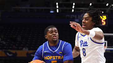 Dec 7, 2025; Pittsburgh, Pennsylvania, USA; Hofstra Pride guard Cruz Davis (5) drives to the basket against Pittsburgh Panthers guard Omari Witherspoon (8) during the second half at the Petersen Events Center. Mandatory Credit: Charles LeClaire-Imagn Images