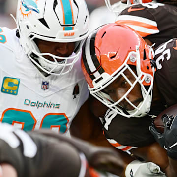 Dec 29, 2024; Cleveland, Ohio, USA; Miami Dolphins defensive tackle Calais Campbell (93) tackles Cleveland Browns running back Jerome Ford (34) during the first half at Huntington Bank Field. Mandatory Credit: Ken Blaze-Imagn Images