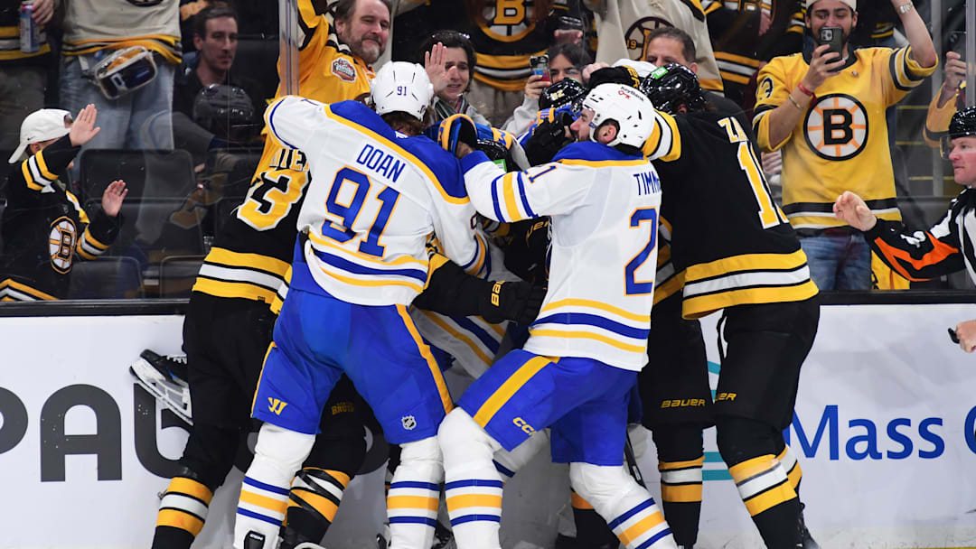 Apr 26, 2026; Boston, Massachusetts, USA; The Boston Bruins and Buffalo Sabres fight along the boards during the third period in game four of the first round of the 2026 Stanley Cup Playoffs at TD Garden. Mandatory Credit: Bob DeChiara-Imagn Images