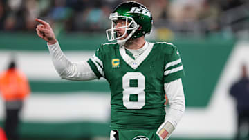 Jan 5, 2025; East Rutherford, New Jersey, USA; New York Jets quarterback Aaron Rodgers (8) gestures towards the Miami Dolphins bench during the second half at MetLife Stadium. Mandatory Credit: Vincent Carchietta-Imagn Images