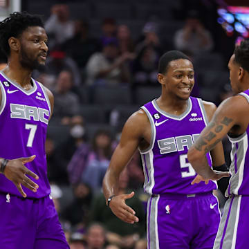 Nov 9, 2022; Sacramento, California, USA; Sacramento Kings guard Malik Monk (0) celebrates with guard De'Aaron Fox (5) and forward Chimezie Metu (7) after making a basket during the second quarter against the Cleveland Cavaliers at Golden 1 Center. Mandatory Credit: Sergio Estrada-Imagn Images