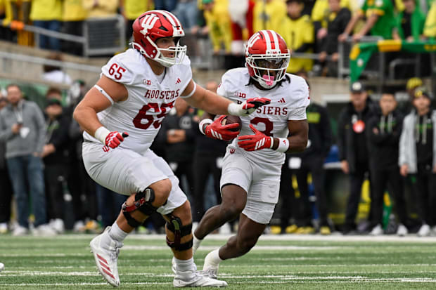 Indiana wide receiver Omar Cooper Jr. runs with the ball and offensive lineman Carter Smith blocks against Oregon.