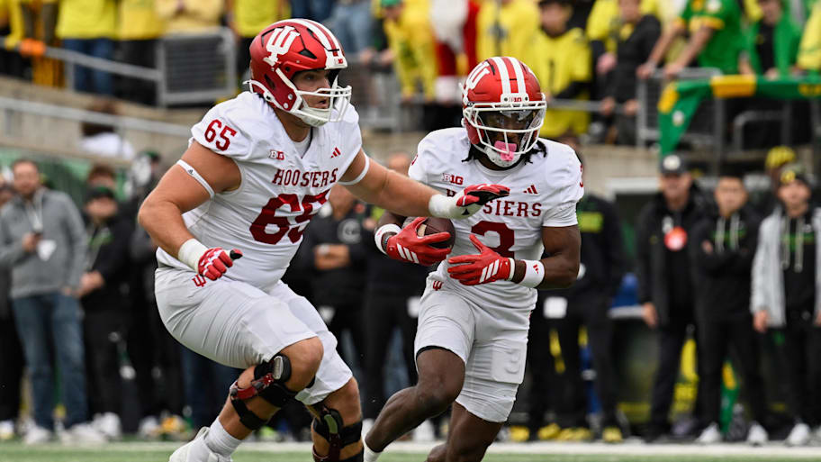Indiana wide receiver Omar Cooper Jr. runs with the ball and offensive lineman Carter Smith blocks against Oregon.