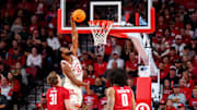 Dec 10, 2025; Lincoln, Nebraska, USA; Nebraska Cornhuskers forward Jared Garcia (15) shoots the ball against Wisconsin Badgers forward Nolan Winter (31) and forward Braeden Carrington (0) during the second half at Pinnacle Bank Arena. 