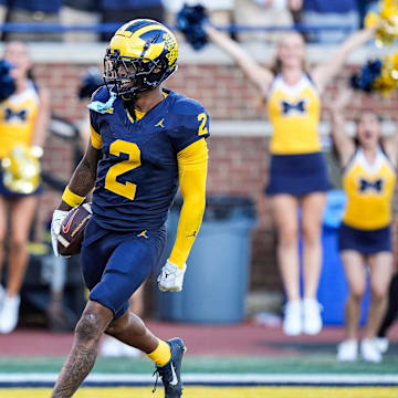 Michigan defensive back Will Johnson celebrates a touchdown after intercepting USC quarterback Miller Moss.