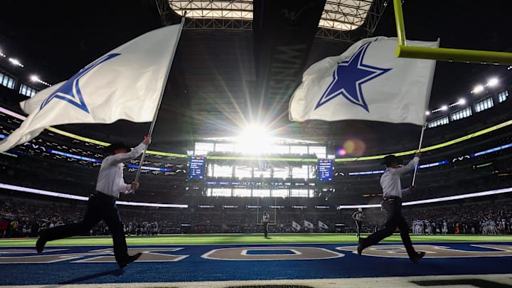 A general view of the field as flag runners run by after a Dallas Cowboys score against the Detroit Lions at AT&T Stadium.  A general view of the field as flag runners run by after a Dallas Cowboys score against the Detroit Lions at AT&T Stadium.