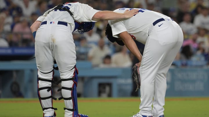 Aug 6, 2024; Los Angeles, California, USA;  Los Angeles Dodgers catcher Will Smith (16) checks on relief pitcher Brusdar Graterol (41) the sixth inning after a hamstring injury against the Philadelphia Phillies at Dodger Stadium. Mandatory Credit: Jayne Kamin-Oncea-USA TODAY Sports