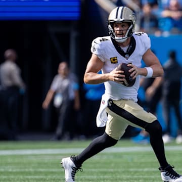 Nov 3, 2024; Charlotte, North Carolina, USA; New Orleans Saints quarterback Derek Carr (4) runs with the ball against the Carolina Panthers during the second quarter of at Bank of America Stadium. Mandatory Credit: Scott Kinser-Imagn Images