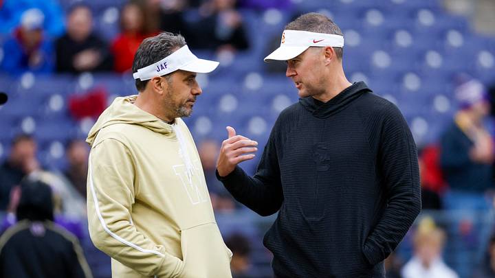 Nov 2, 2024; Seattle, Washington, USA; Washington Huskies head coach Jedd Fisch, left, talks with USC Trojans head coach Lincoln Riley during pregame warmups at Alaska Airlines Field at Husky Stadium. Mandatory Credit: Joe Nicholson-Imagn Images